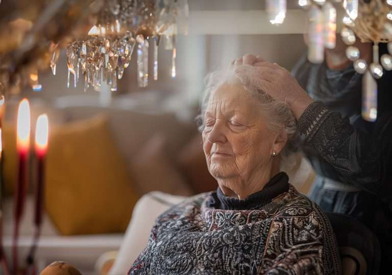 old lady getting massage in palliative care with massage therapists